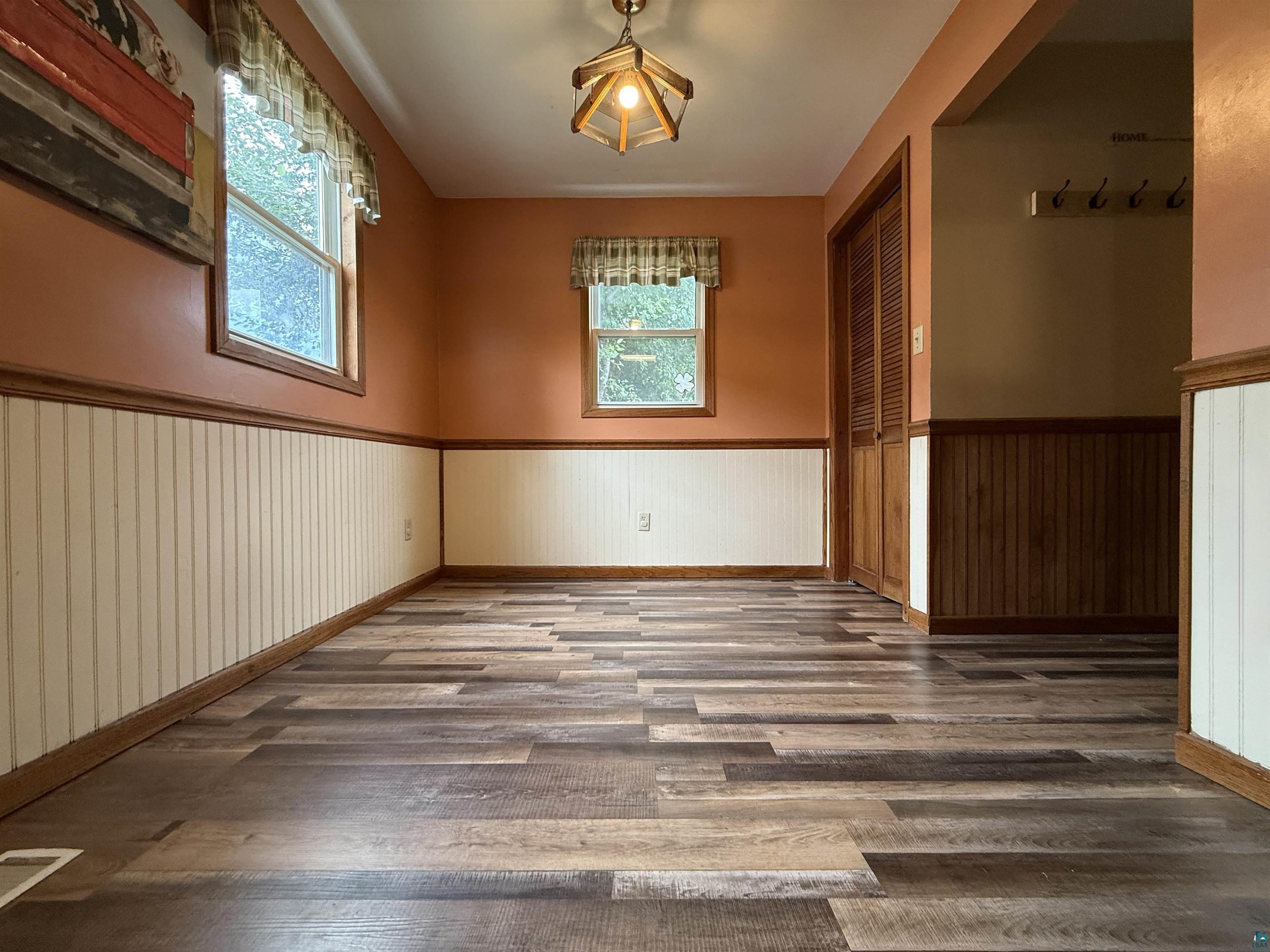 809 16th Street North Virginia, MN 55792 - Photo 22 of 44 Spare room featuring wainscoting and wood finished floors