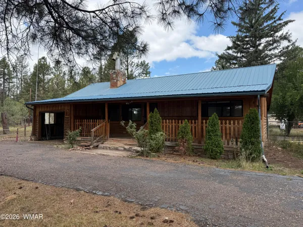 a front view of a house with yard patio and porch