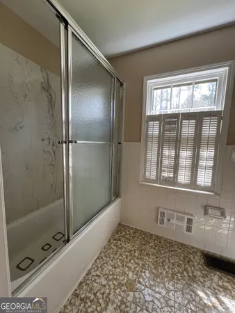 a bathroom with a tub and a shower