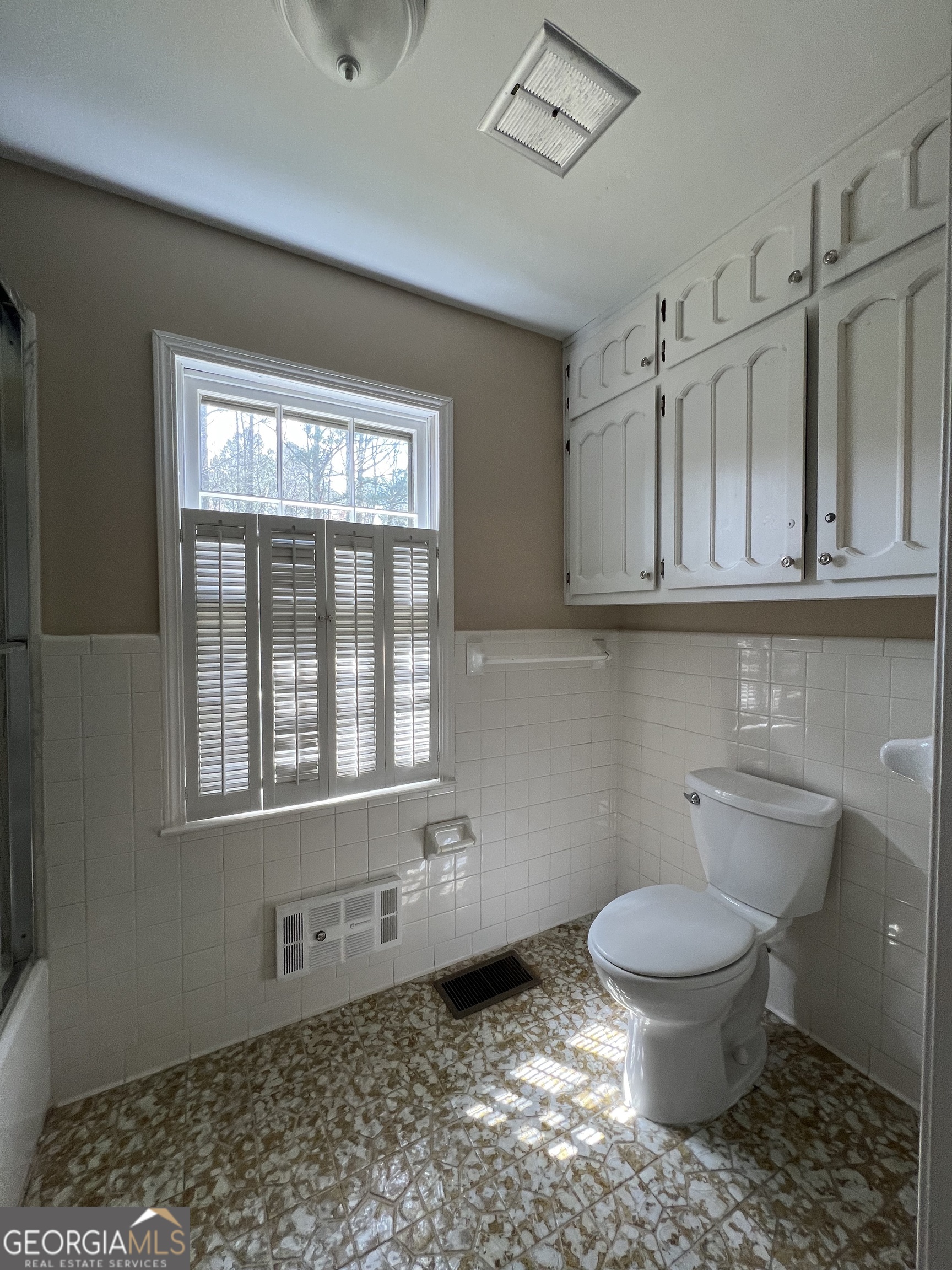 115 Old Stone Road Villa Rica, GA 30180 - Photo 12 of 18 a bathroom with a toilet a sink and a window
