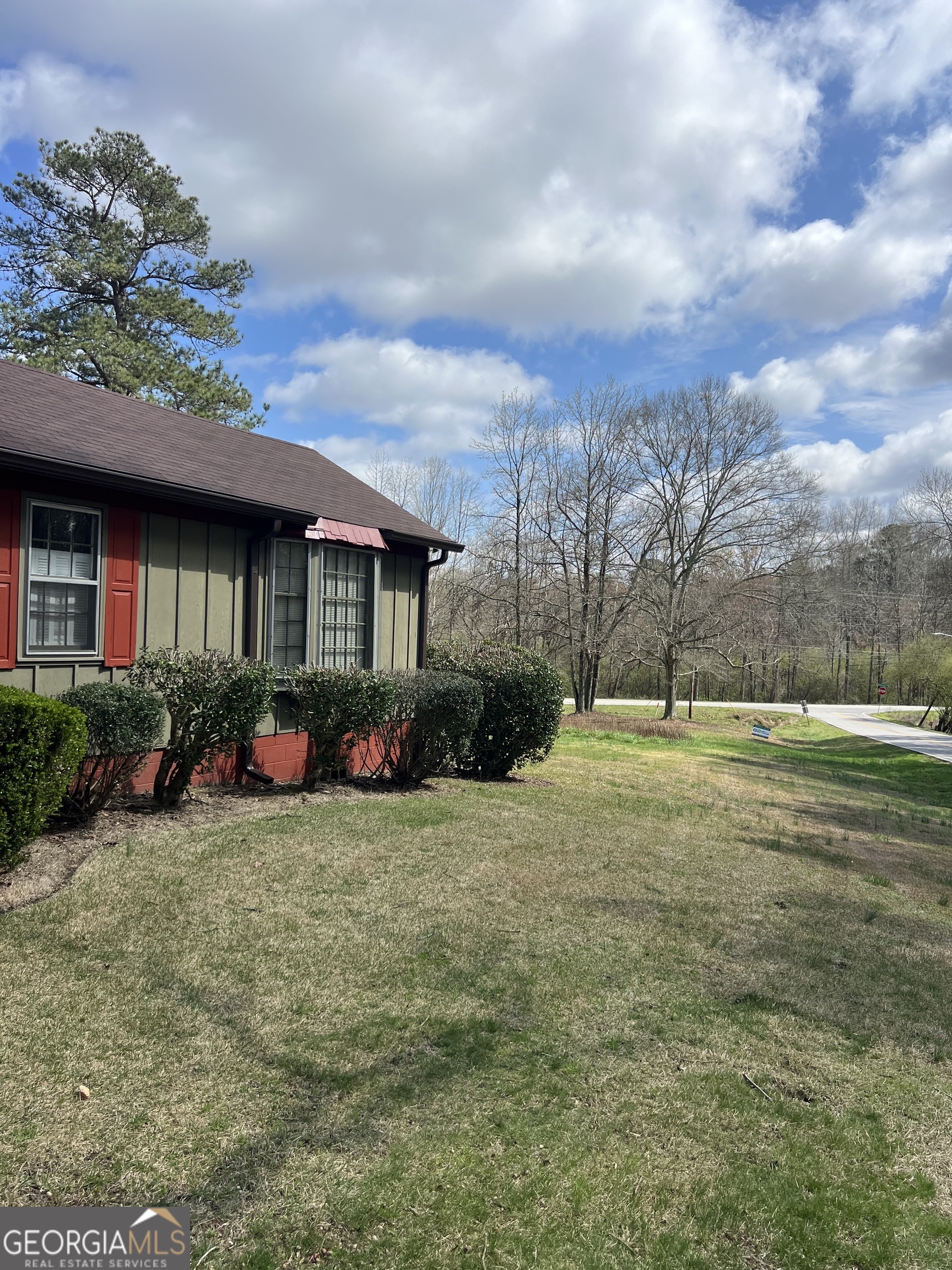 115 Old Stone Road Villa Rica, GA 30180 - Photo 2 of 18 a view of a house with a big yard and potted plants