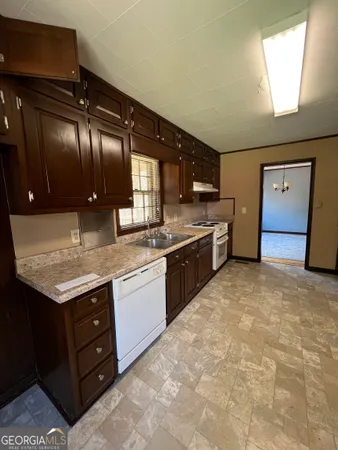 a kitchen with a stove a sink and a refrigerator