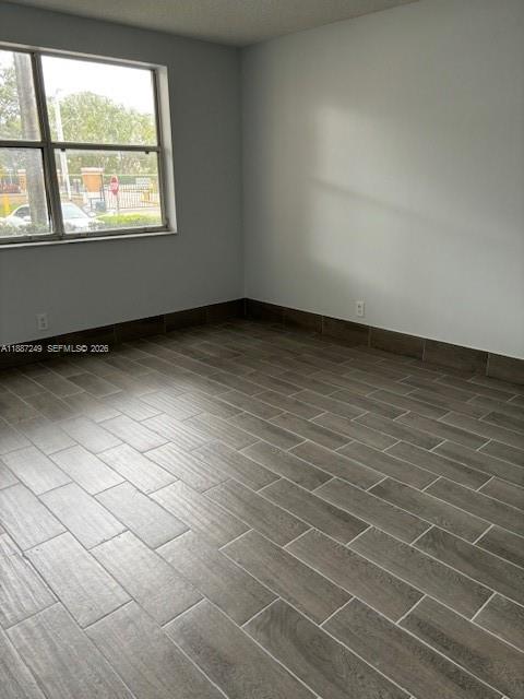 8701 Wiles Road, Unit 103 Coral Springs, FL 33067 - Photo 4 of 15 an empty room with a window