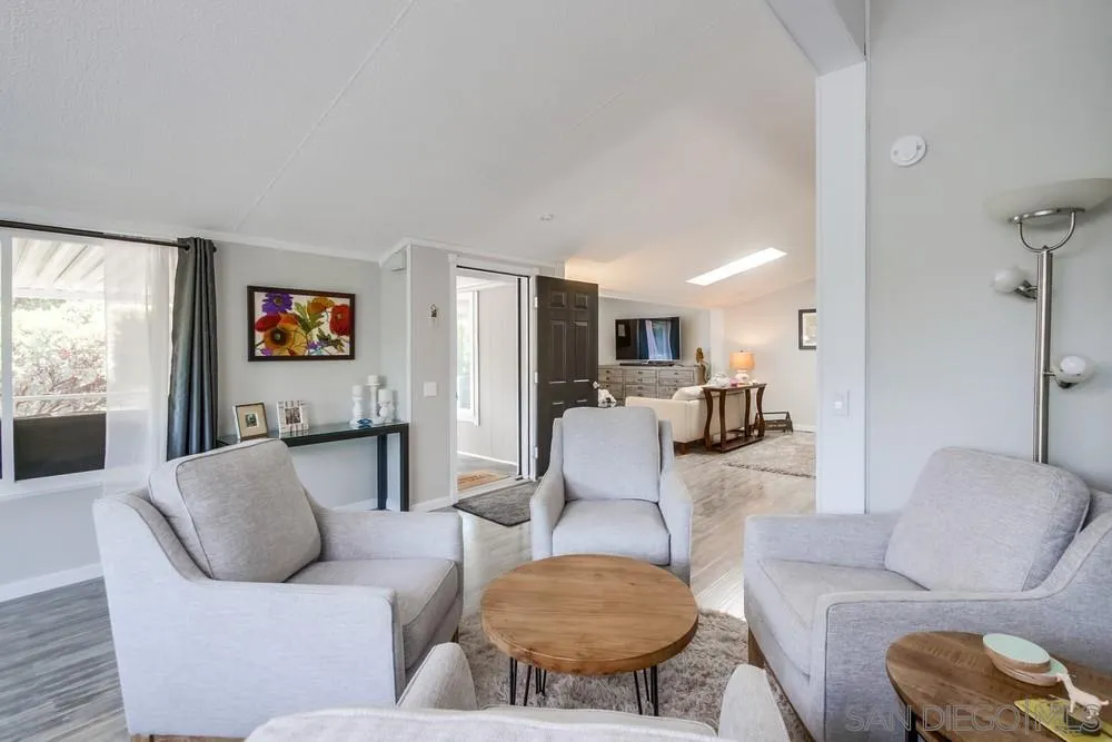18218 Paradise Mountain Road, Unit 75 Valley Center, CA 92082 - Photo 11 of 68 a living room with furniture kitchen view and a large window
