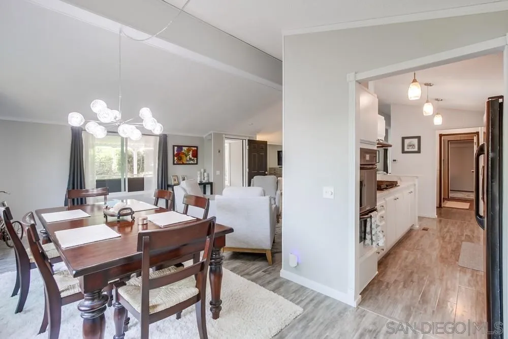18218 Paradise Mountain Road, Unit 75 Valley Center, CA 92082 - Photo 12 of 68 a view of a dining room with furniture and wooden floor