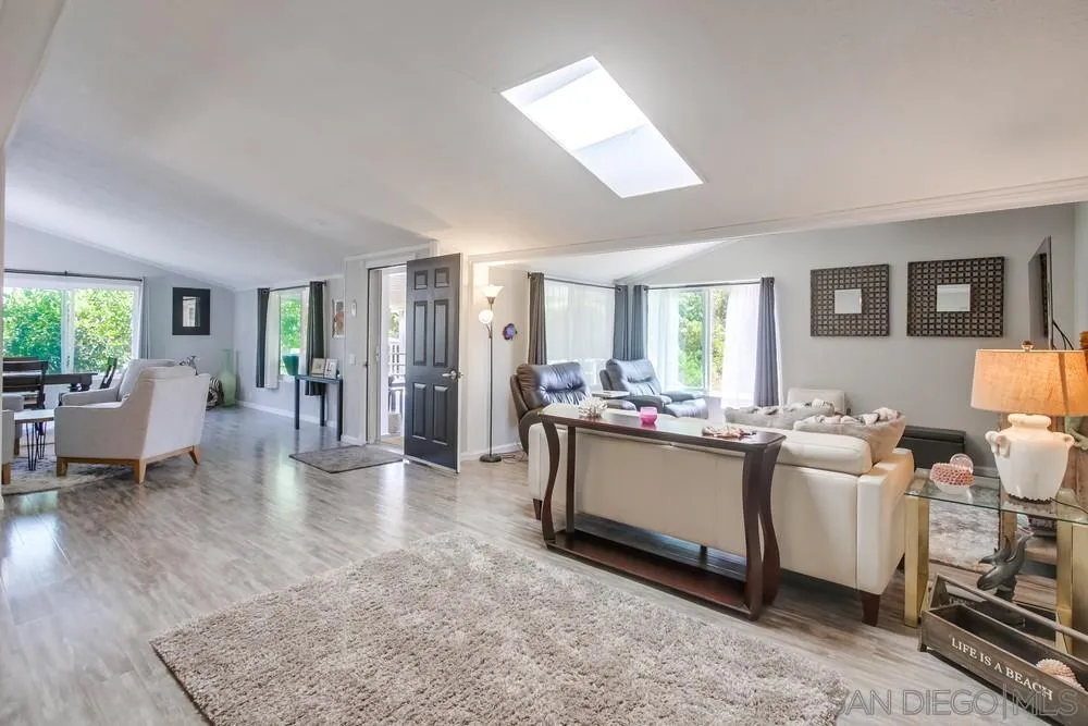 18218 Paradise Mountain Road, Unit 75 Valley Center, CA 92082 - Photo 18 of 68 a living room with fireplace furniture and a large window