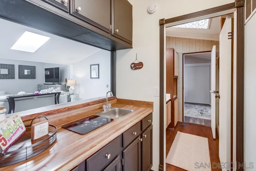 18218 Paradise Mountain Road, Unit 75 Valley Center, CA 92082 - Photo 24 of 68 a view of a kitchen area with furniture and wooden floor