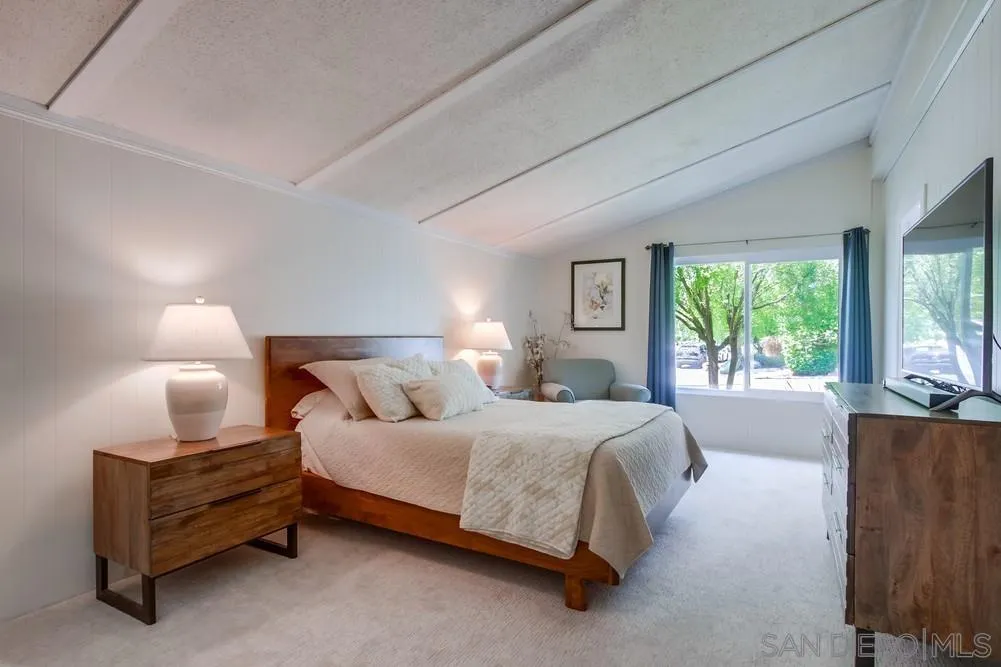 18218 Paradise Mountain Road, Unit 75 Valley Center, CA 92082 - Photo 28 of 68 a bedroom with a bed and window
