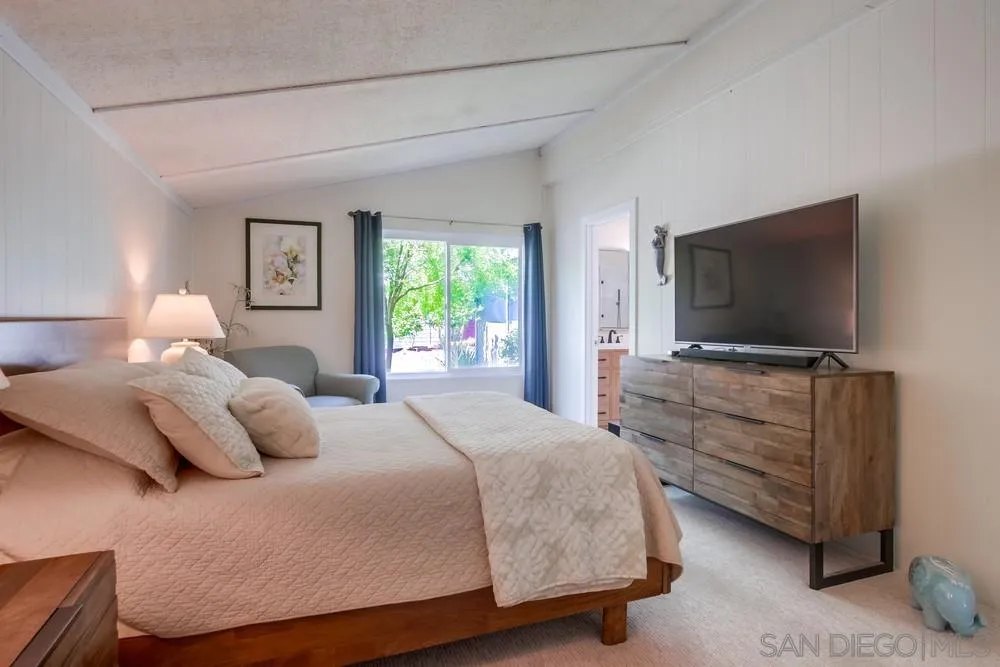 18218 Paradise Mountain Road, Unit 75 Valley Center, CA 92082 - Photo 29 of 68 a bedroom with a bed and a flat screen tv