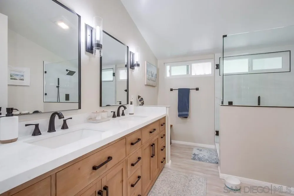 18218 Paradise Mountain Road, Unit 75 Valley Center, CA 92082 - Photo 32 of 68 a bathroom with a double vanity sink and mirror