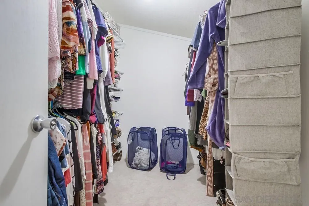 18218 Paradise Mountain Road, Unit 75 Valley Center, CA 92082 - Photo 35 of 68 a view of walk in closet with clothes