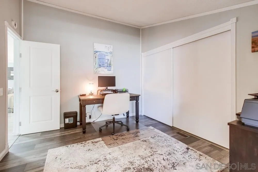 18218 Paradise Mountain Road, Unit 75 Valley Center, CA 92082 - Photo 37 of 68 a workspace with furniture and a wooden floor