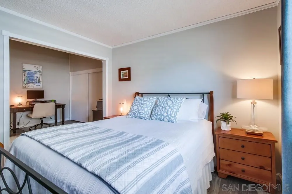 18218 Paradise Mountain Road, Unit 75 Valley Center, CA 92082 - Photo 40 of 68 a bedroom with a bed and a lamp on dresser