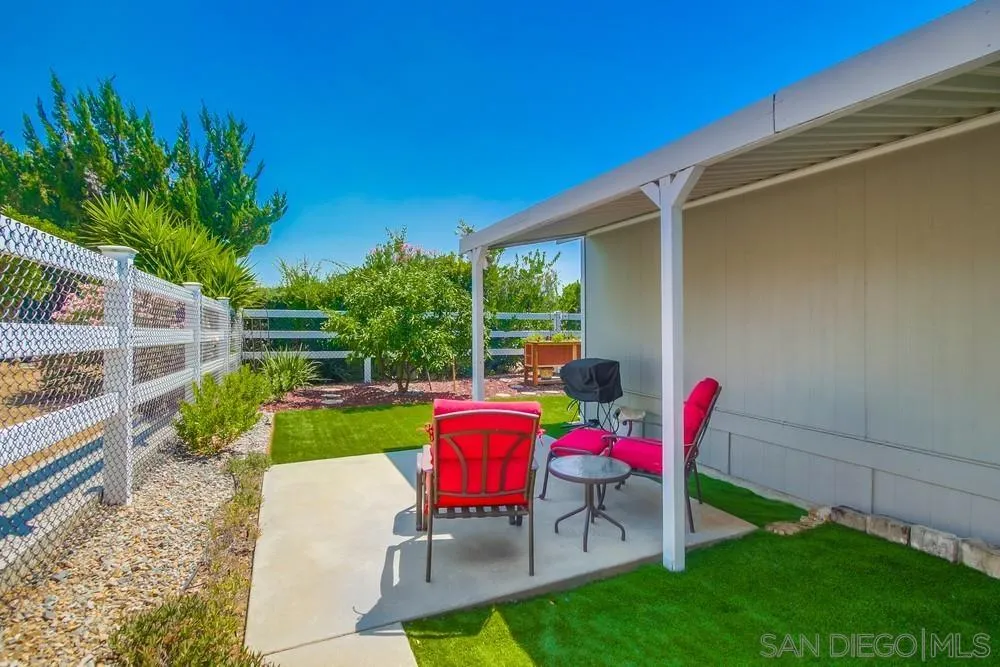 18218 Paradise Mountain Road, Unit 75 Valley Center, CA 92082 - Photo 53 of 68 a view of backyard with seating and green space