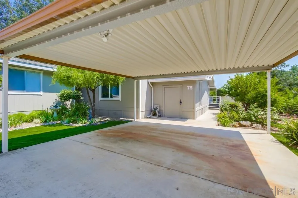 18218 Paradise Mountain Road, Unit 75 Valley Center, CA 92082 - Photo 6 of 68 a front view of a house with a yard and potted plants