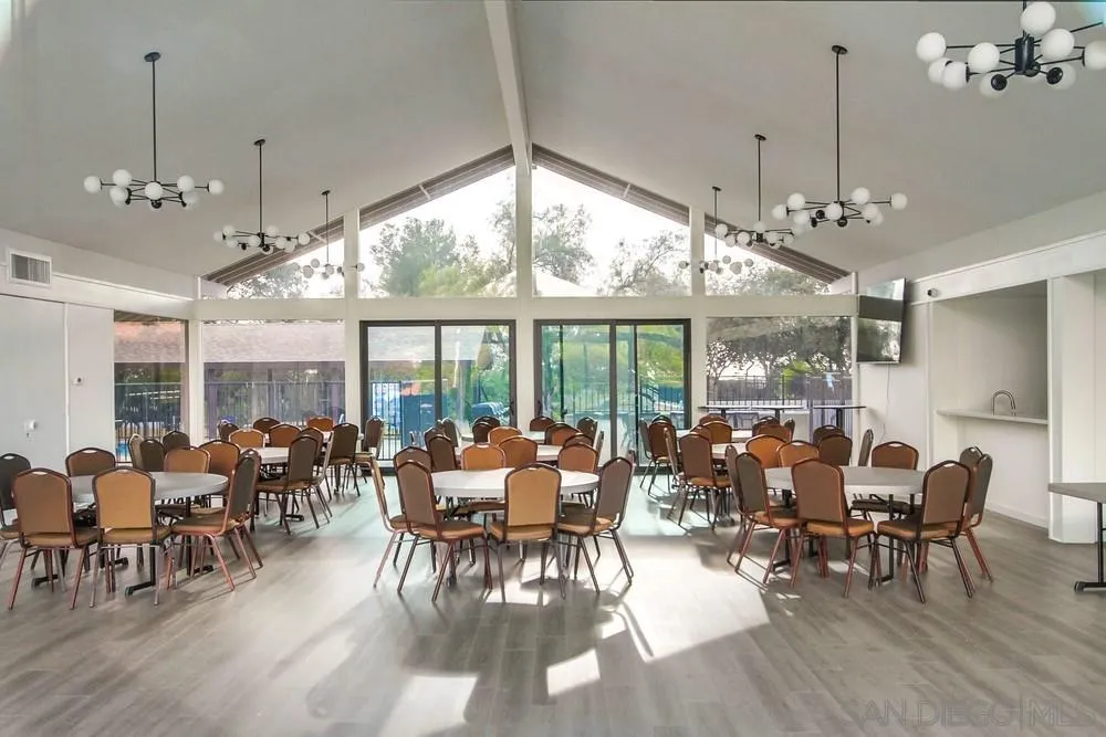 18218 Paradise Mountain Road, Unit 75 Valley Center, CA 92082 - Photo 64 of 68 a view of a dining room with furniture large windows and wooden floor