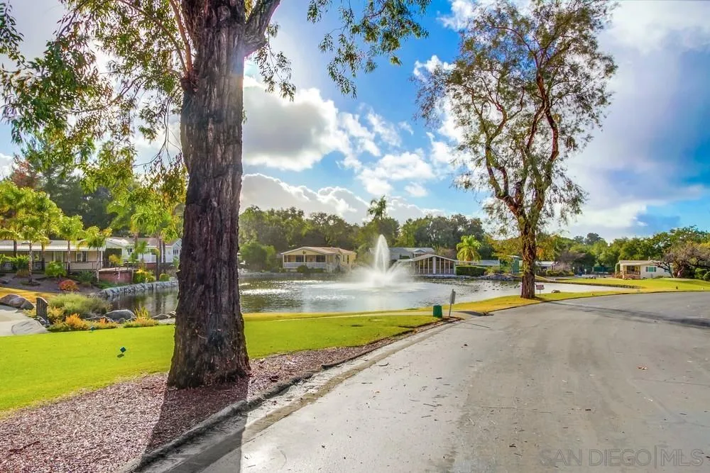 18218 Paradise Mountain Road, Unit 75 Valley Center, CA 92082 - Photo 66 of 68 a view of a swimming pool with an outdoor space and seating area