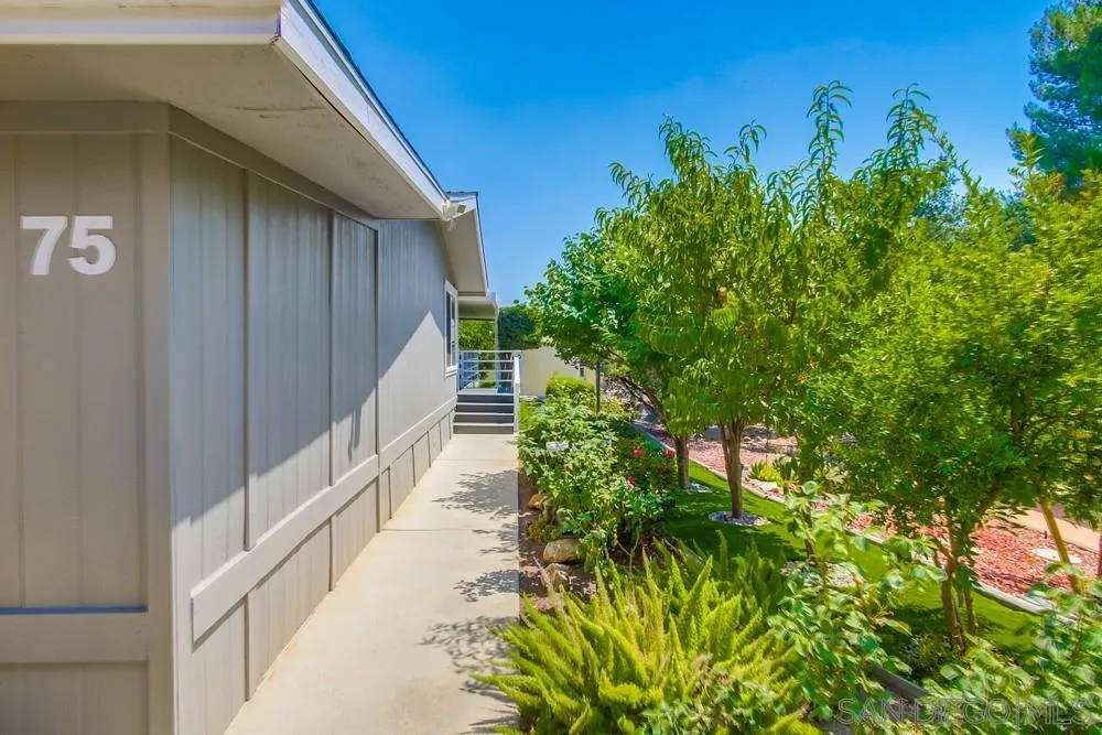 18218 Paradise Mountain Road, Unit 75 Valley Center, CA 92082 - Photo 7 of 68 a view of a pathway of a yard