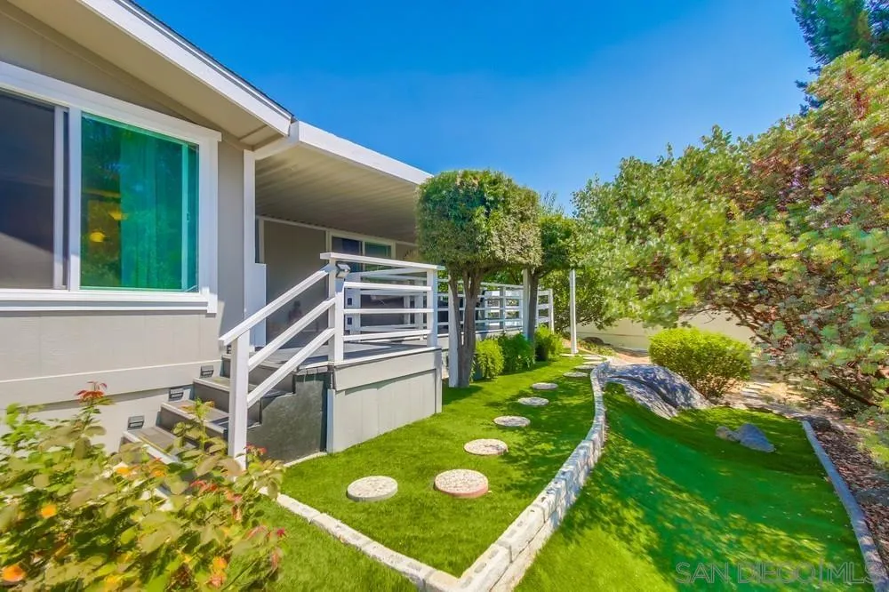 18218 Paradise Mountain Road, Unit 75 Valley Center, CA 92082 - Photo 8 of 68 a backyard of a house with table and chairs