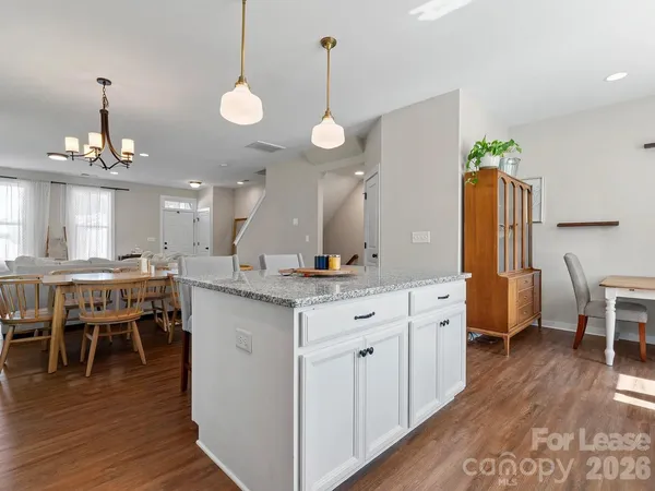 a large kitchen with a table and chairs
