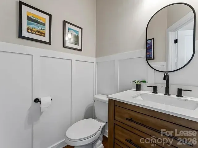 a bathroom with a toilet a sink and mirror