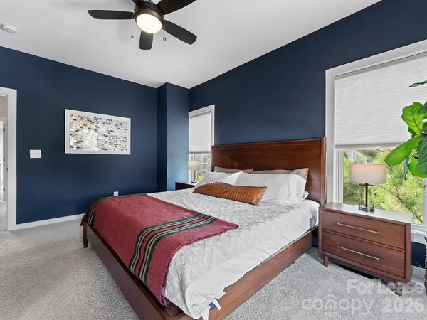 a bedroom with a bed and a large window