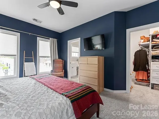 a bedroom with a bed and a television