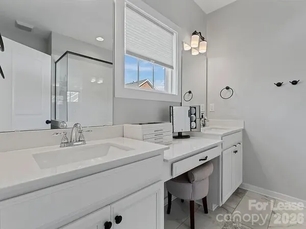 a bathroom with a double vanity sink mirror and