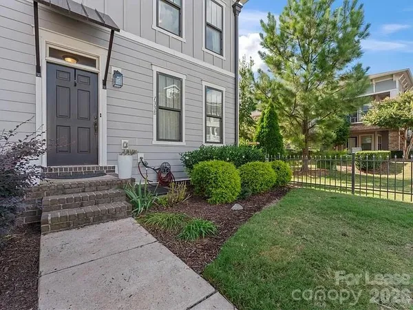 a view of a house with a yard and plants