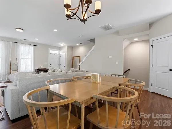 a kitchen with a table chairs sink and cabinets