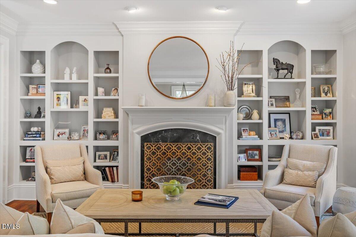 1015 Harvey Street Raleigh, NC 27608 - Photo 10 of 95 a living room with furniture a fireplace and a bookshelf