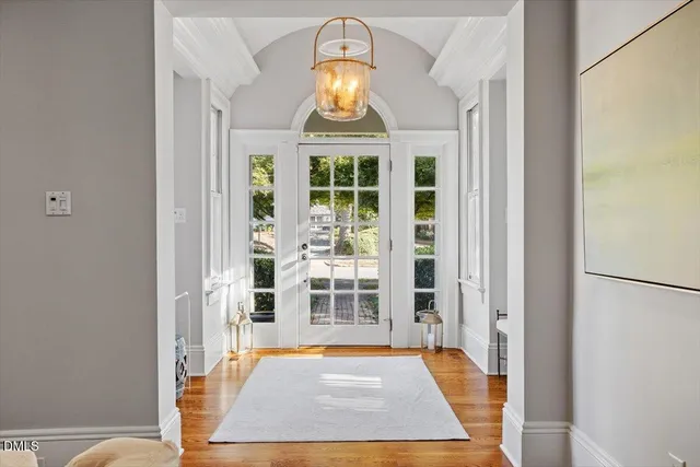 a view of a dining room with furniture and chandelier