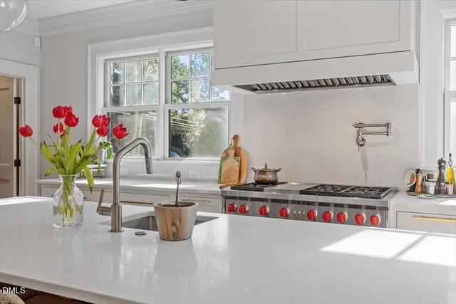 a bedroom with bed and a large window