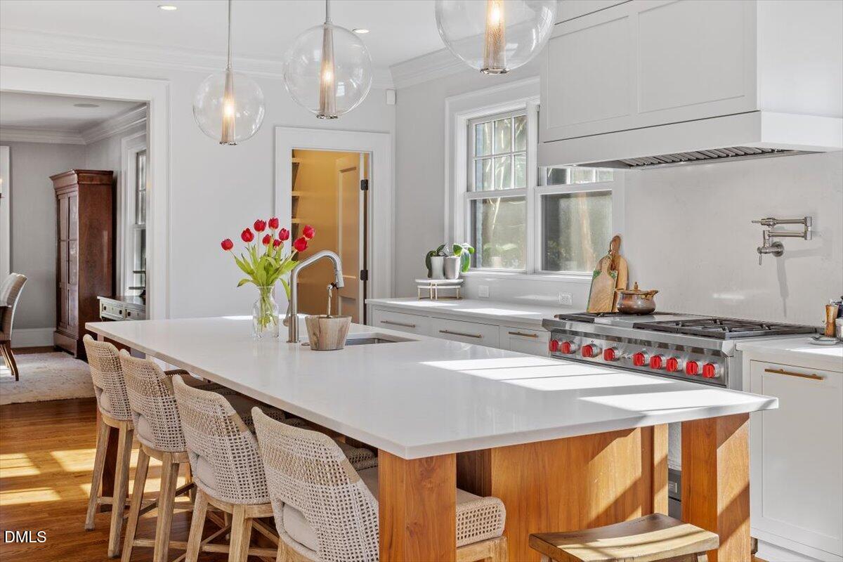 1015 Harvey Street Raleigh, NC 27608 - Photo 24 of 95 a view of a dining room with furniture and chandelier