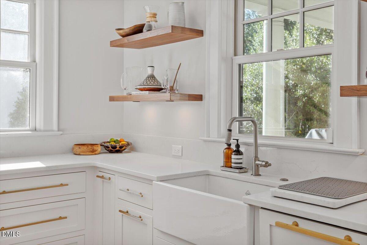 1015 Harvey Street Raleigh, NC 27608 - Photo 26 of 95 a kitchen with a cabinets a sink and a window