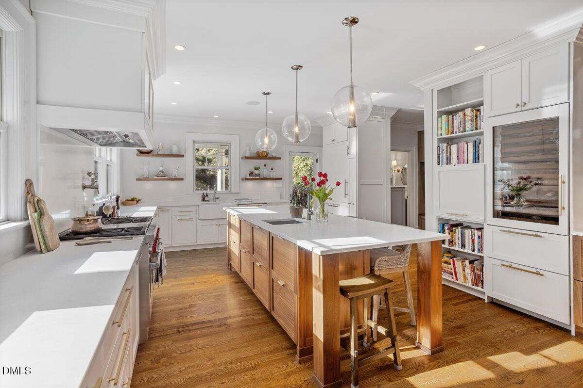 1015 Harvey Street Raleigh, NC 27608 - Photo 2 of 95 a kitchen with stainless steel appliances a stove a sink a oven a dining table and chairs