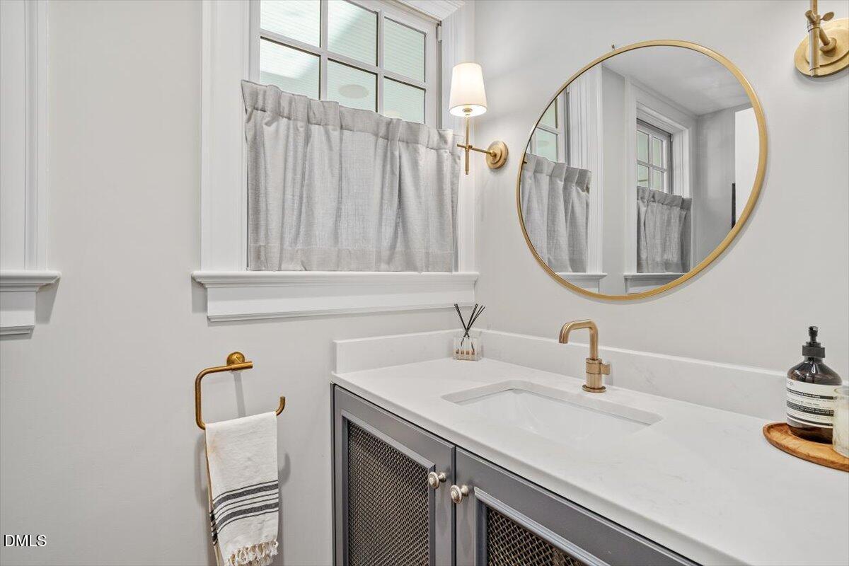 1015 Harvey Street Raleigh, NC 27608 - Photo 30 of 95 a bathroom with a sink and a mirror