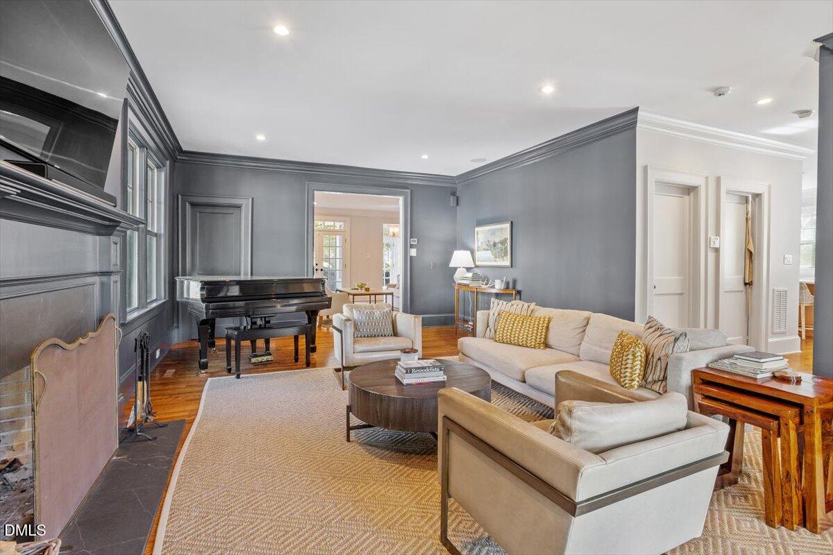 1015 Harvey Street Raleigh, NC 27608 - Photo 33 of 95 a living room with furniture kitchen view and a wooden floor