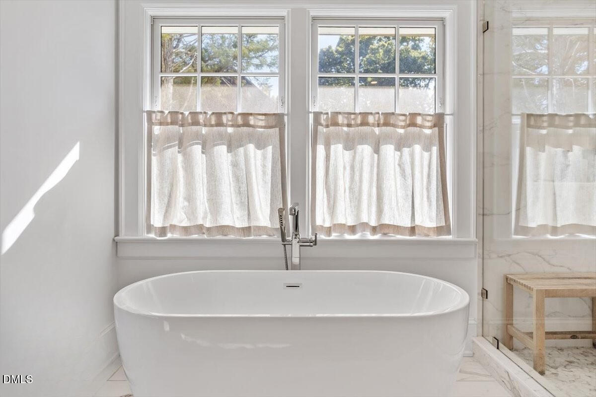 1015 Harvey Street Raleigh, NC 27608 - Photo 43 of 95 a white bath tub sitting next to a window