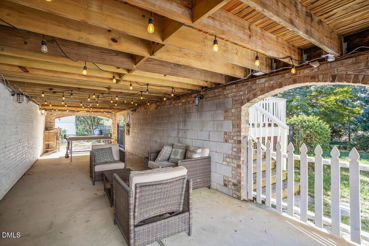 1015 Harvey Street Raleigh, NC 27608 - Photo 61 of 95 a view of a patio with table and chairs with wooden floor