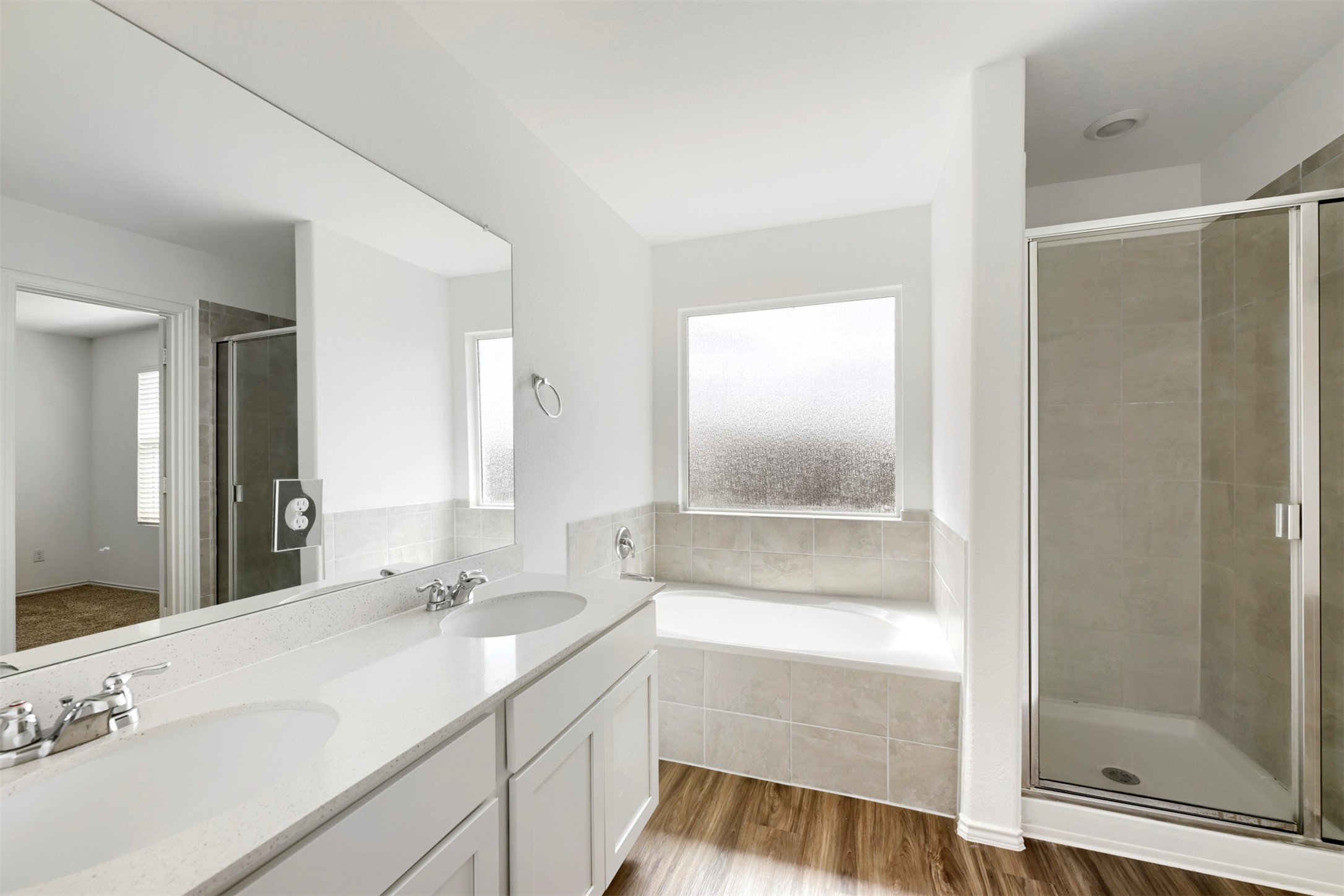 120 Milliner Loop Hutto, TX 78634 - Photo 8 of 15 Dual vanities complement a soaking tub and a separate glass-enclosed shower in this well-appointed bath.