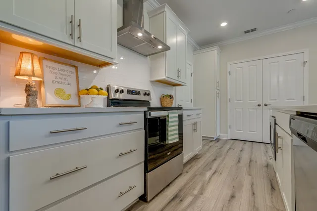 a kitchen with stainless steel appliances granite countertop a stove and a refrigerator