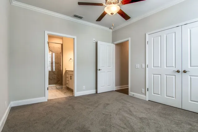 an empty room with chandelier fan
