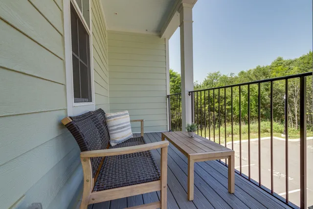 a view of balcony with wooden floor and outdoor seating