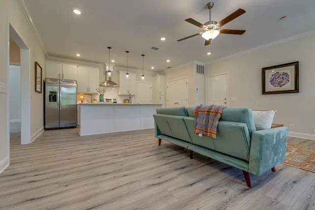 a living room with furniture and kitchen view