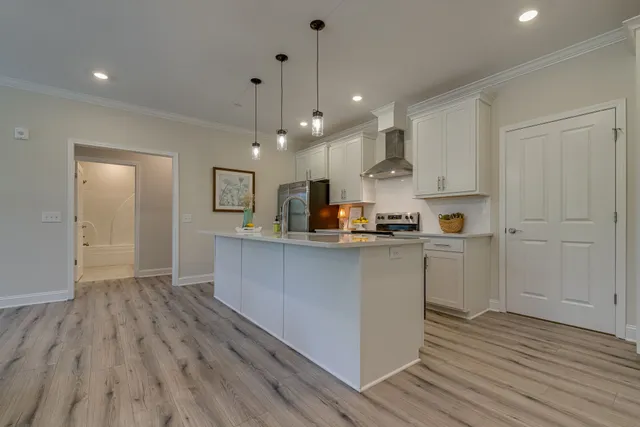 a kitchen with cabinets a sink and wooden floor