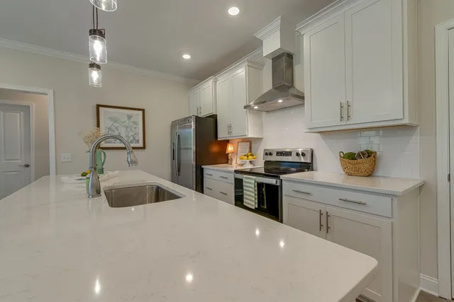a kitchen with stainless steel appliances a sink stove and refrigerator