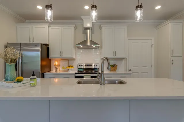 a kitchen with stainless steel appliances refrigerator and microwave