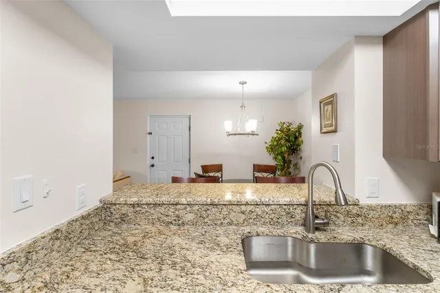 a view of a hallway with wooden floor and a bathroom