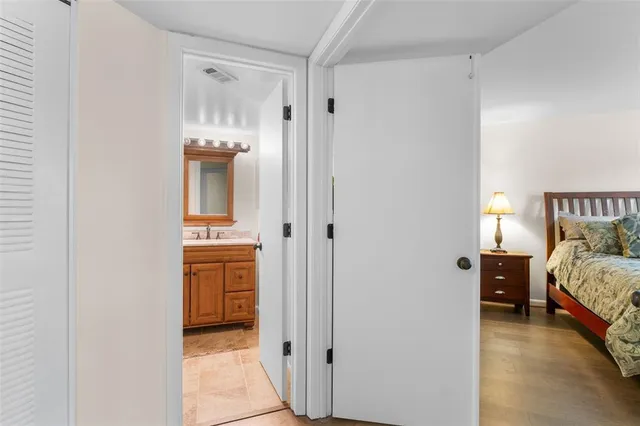 a bathroom with a sink a toilet and a large mirror